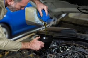 mechanic-pouring-oil-into-car-engine